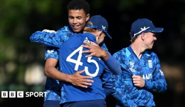 Manny Lumsden celebrates taking a wicket against New Zealand with his England team-mates