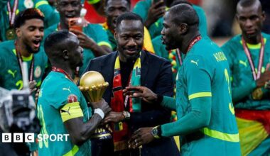 Pape Thiaw and the Senegal players celebrate with the trophy after winning the Africa Cup of Nations