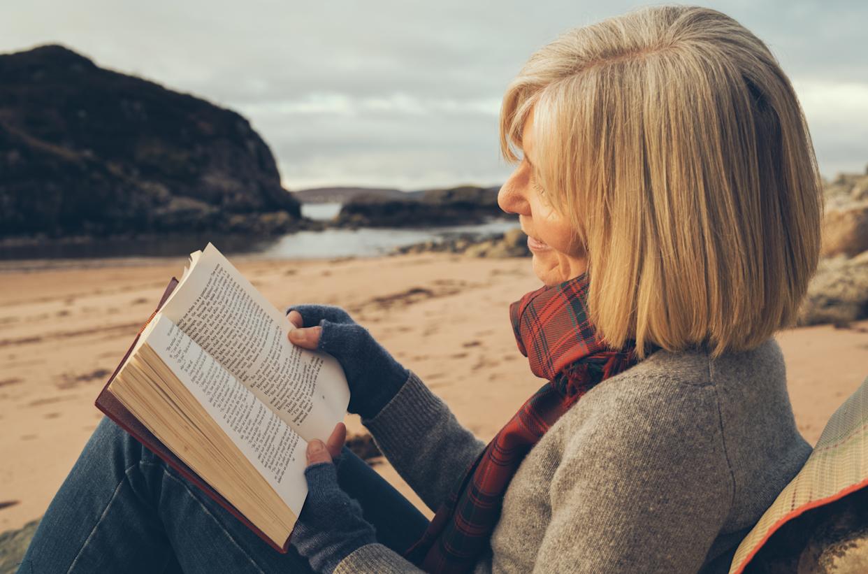 Senior woman on the beach at Gruinard Bay, Ross and Cromarty, Scotland. Off season, beach all to herself.
