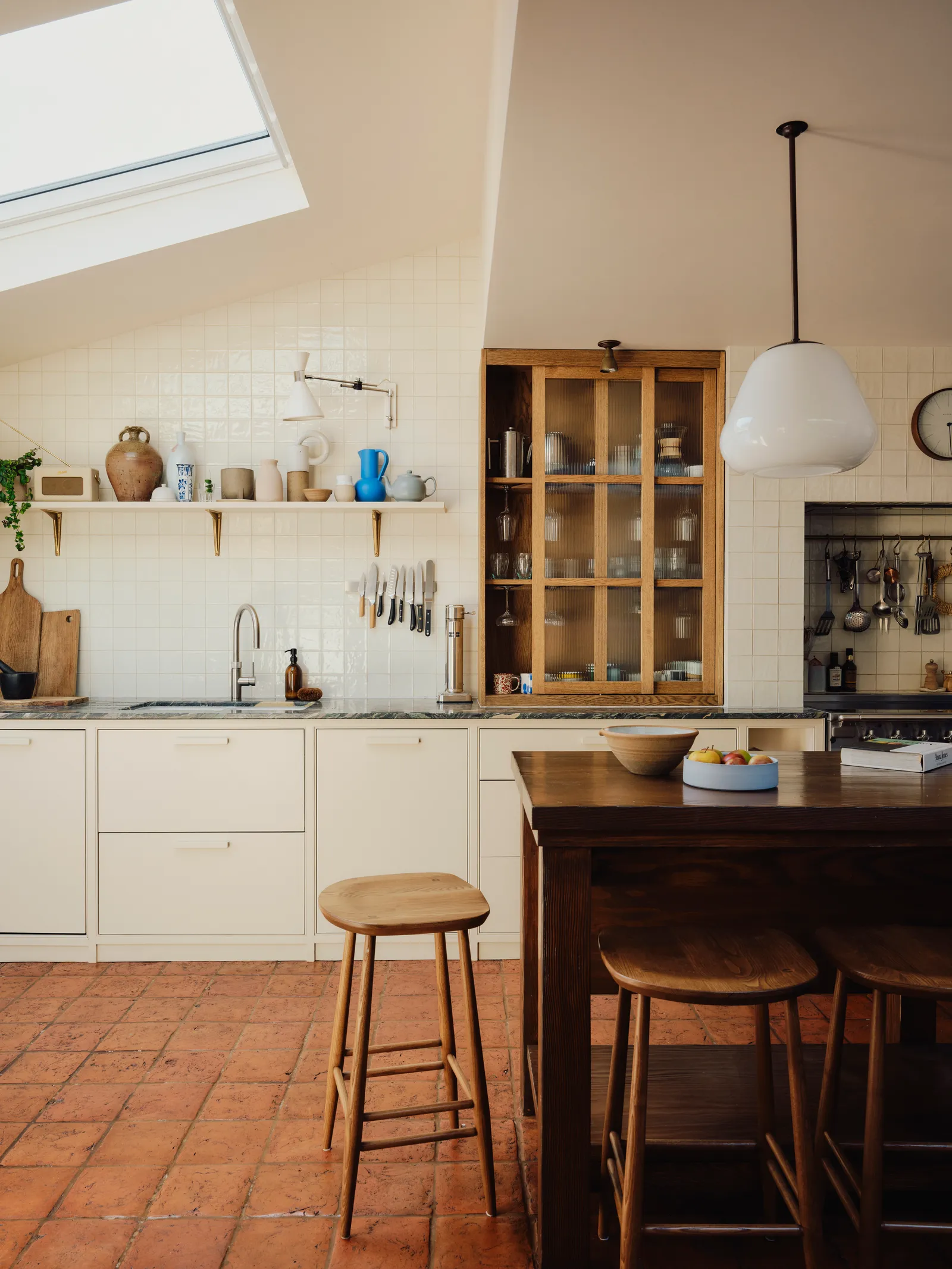vintage kitchen wooden stool terracotta floor tiles white tile kitchen skylight house and garden field day studio london...