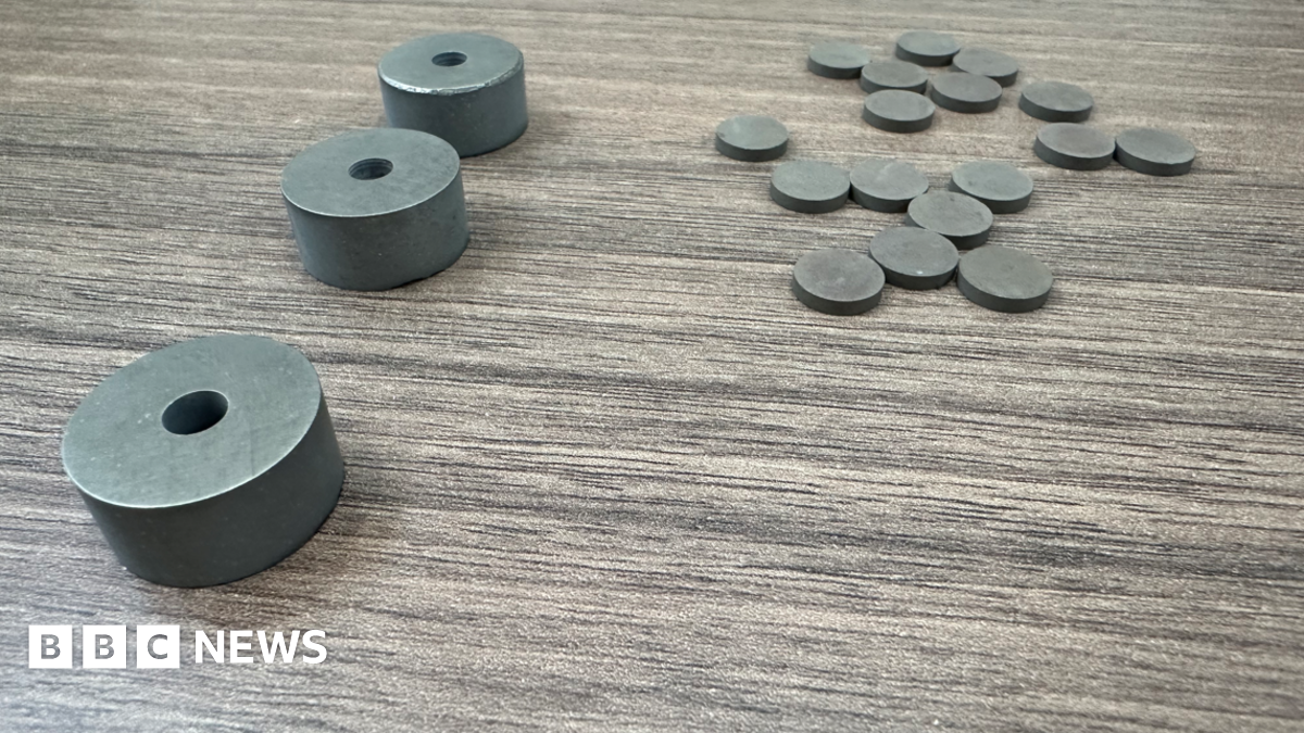 There are three objects on the left and more than a dozen smaller objects shaped like coins on the right.