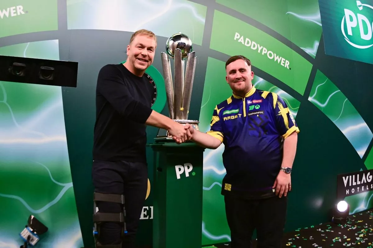 Luke Littler shakes hands with Sir Chris Hoy during the 2025/26 Paddy Power World Darts Championships final