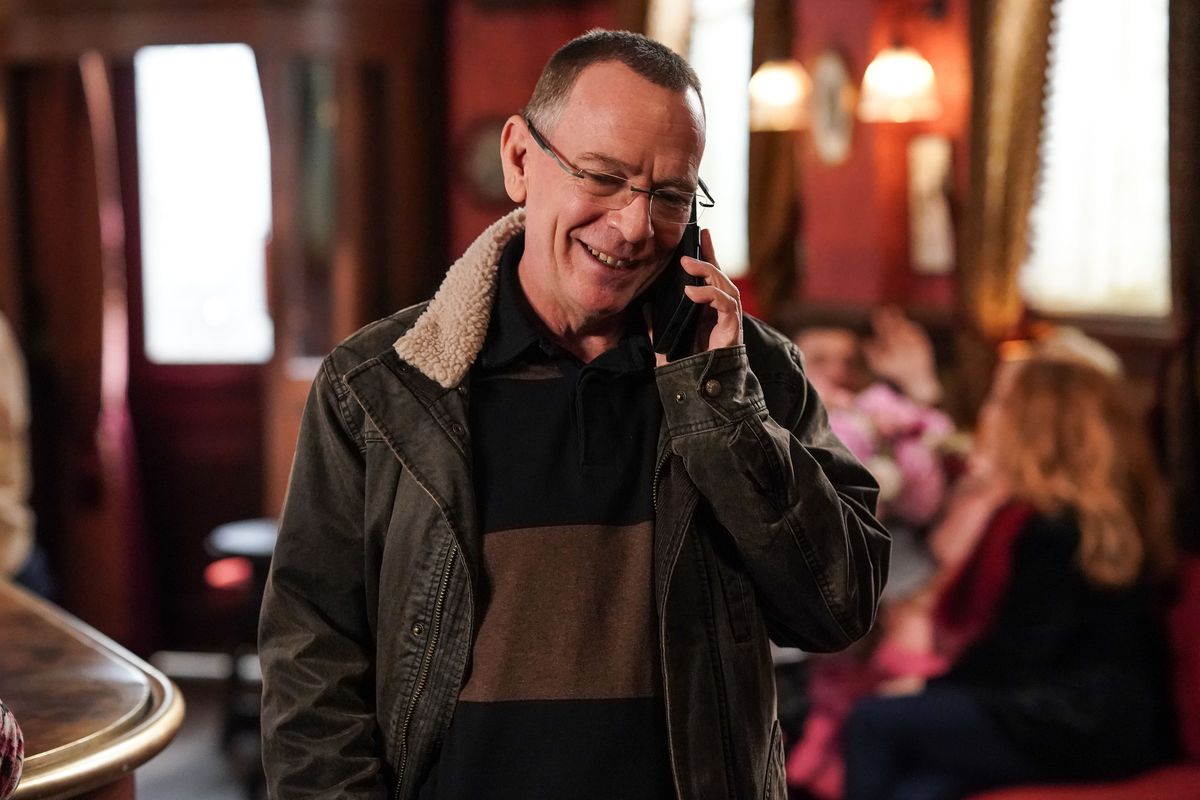 Ian Beale talks on his mobile phone while standing in The Queen Vic 