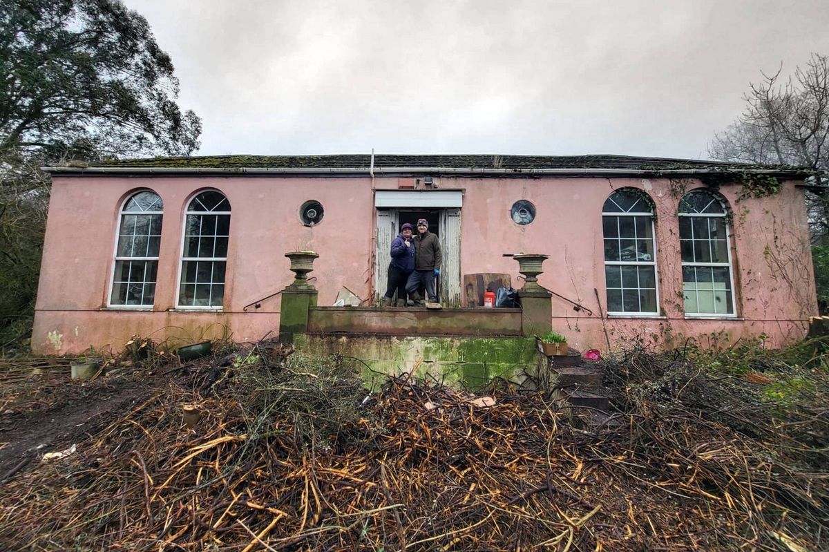 After clearing bushes and trees, Ryan and Jen can now reach the front door without battling brambles at an abandoned pink painted house on Isle of Anglesey that they bought without viewing