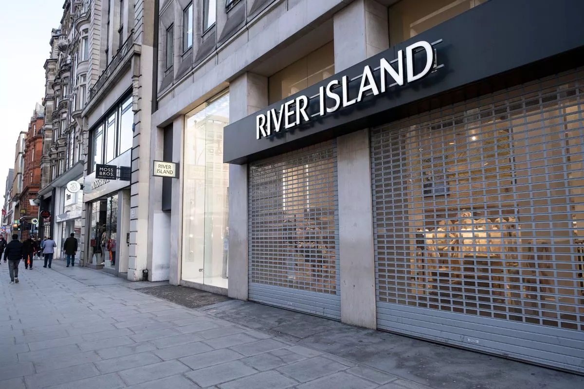 The front of a River Island store with shutters down