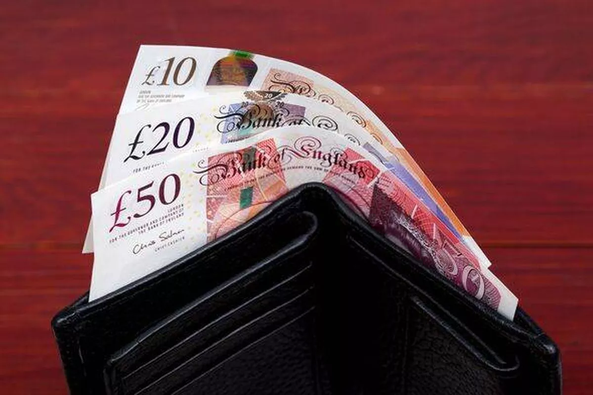 English money - pounds in a black wallet