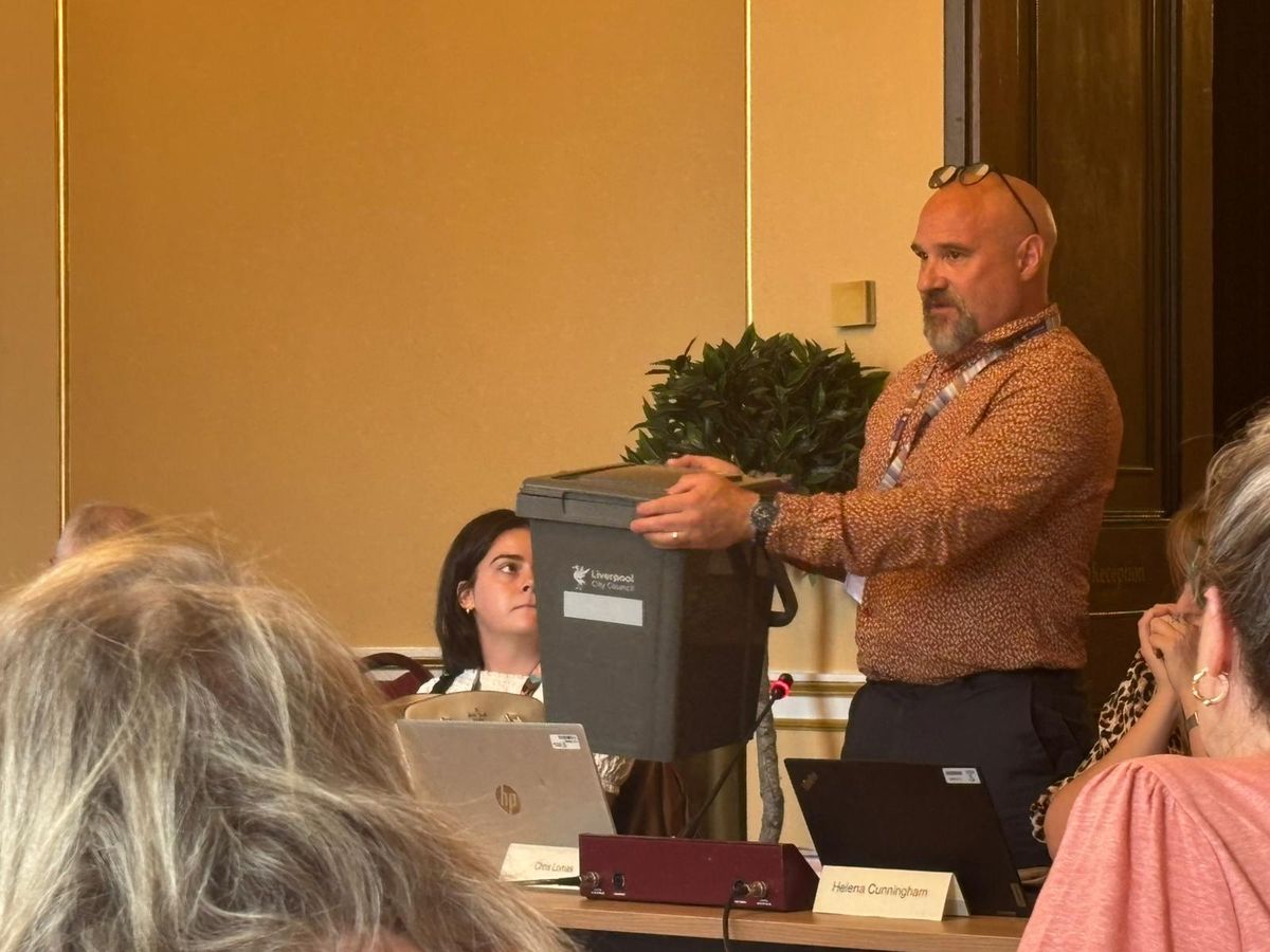 Chris Lomas, director of environmental services, presents a new food waste bin