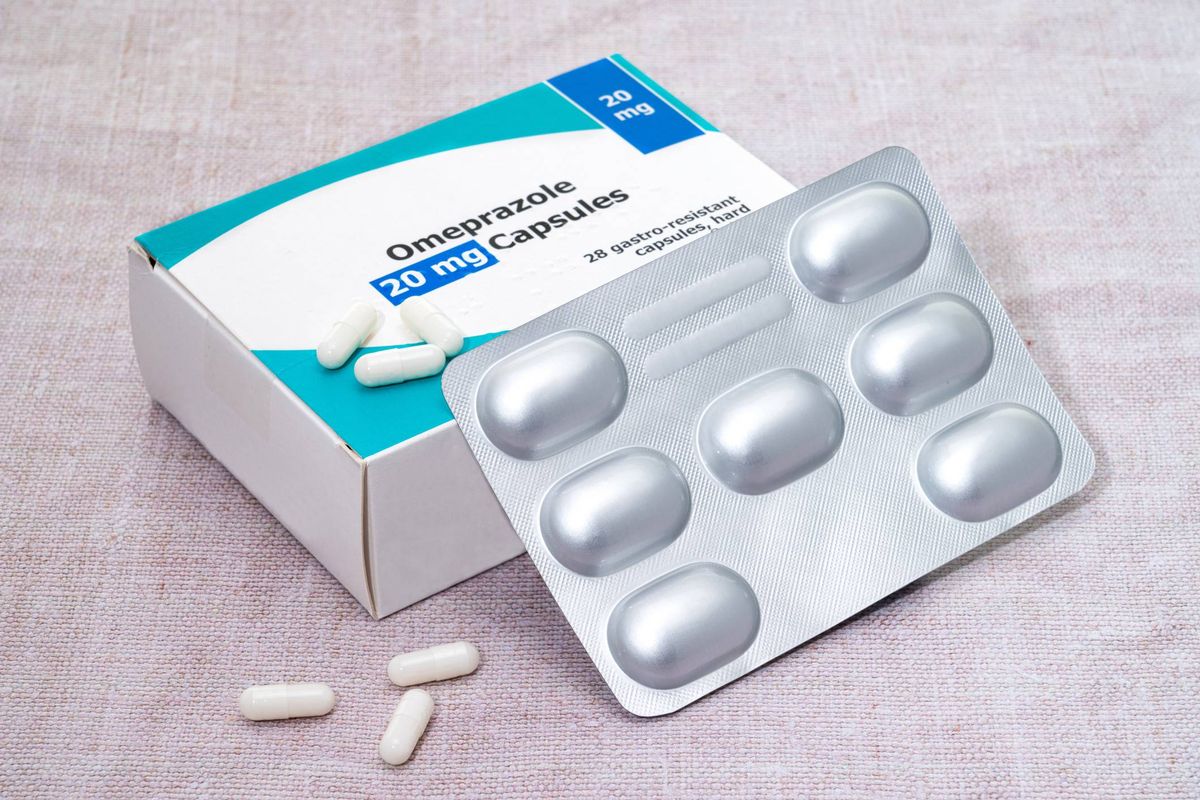A box and blister pack of generic Omeprazole pills