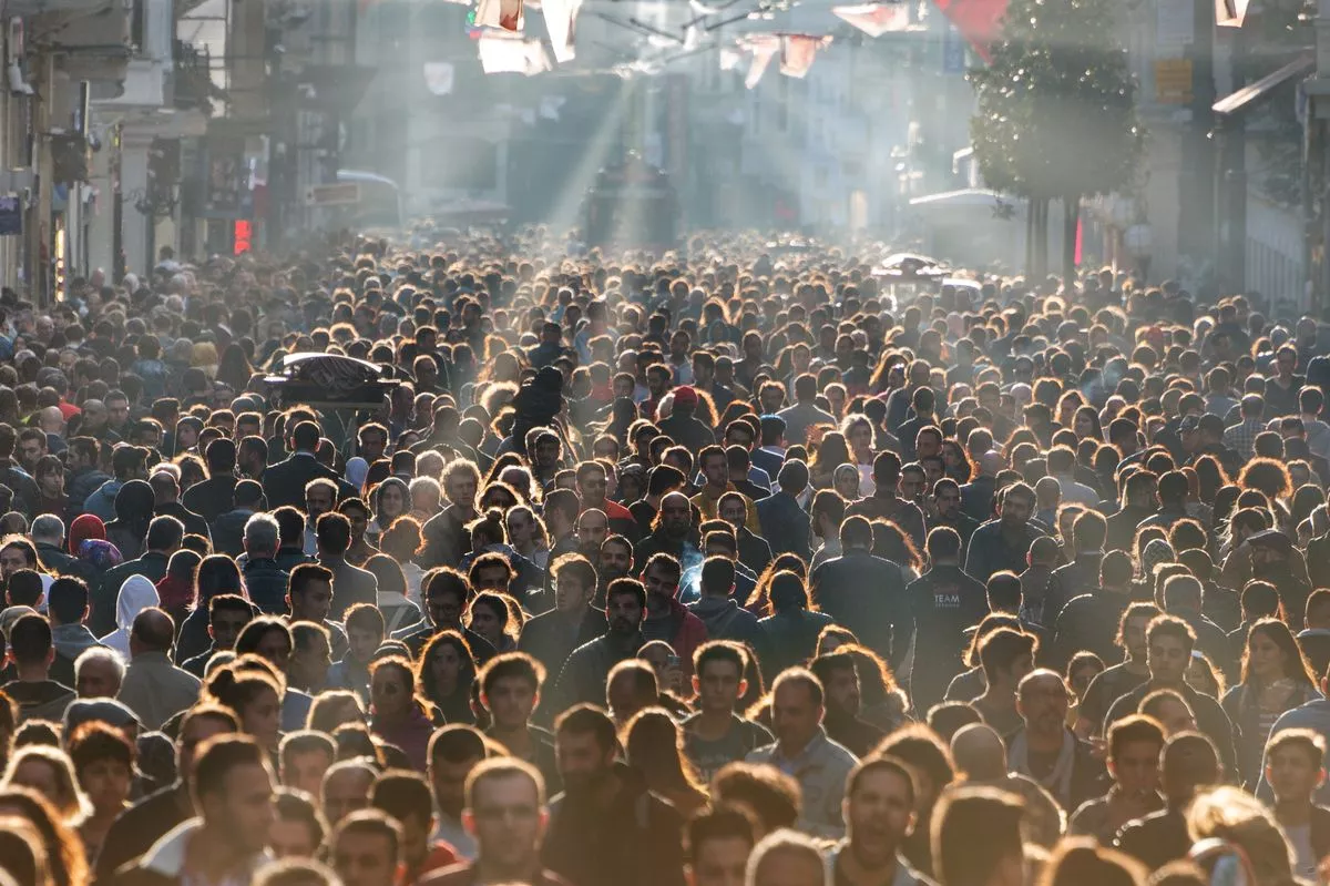 Huge crowd on a Saturday afternoon with reverse light in Istiklal Street(from Taksim Square nearly all the way to the landmark Galata Tower. It is the beating heart of the city, the three million people that pass it every day) in Taksim, Beyoglu District of Istanbul.
