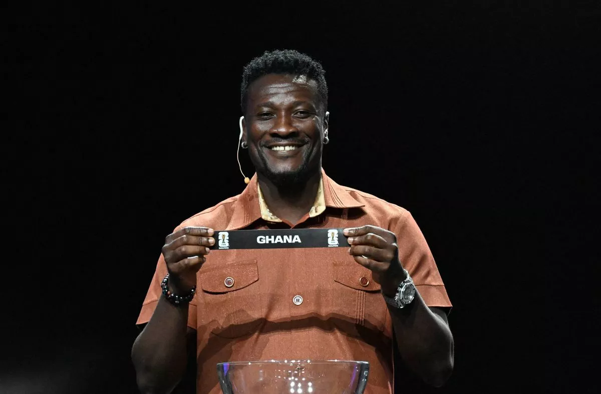 Former Ghanaian football player Asamoah Gyan shows the ticket of Ghana during the qualifying draw for the Africa zone of the 2026 FIFA World Cup