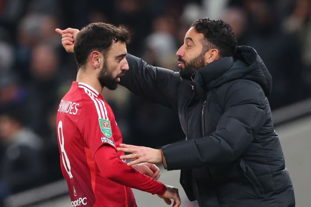 Ruben Amorim (right) speaks with Man Utd captain Bruno Fernandes.