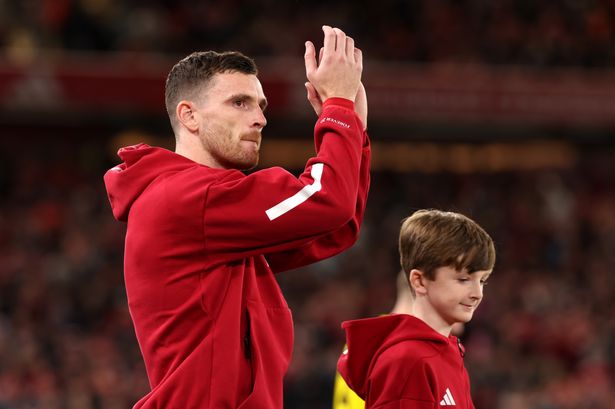 Andy Robertson applauds Liverpool's fans. 