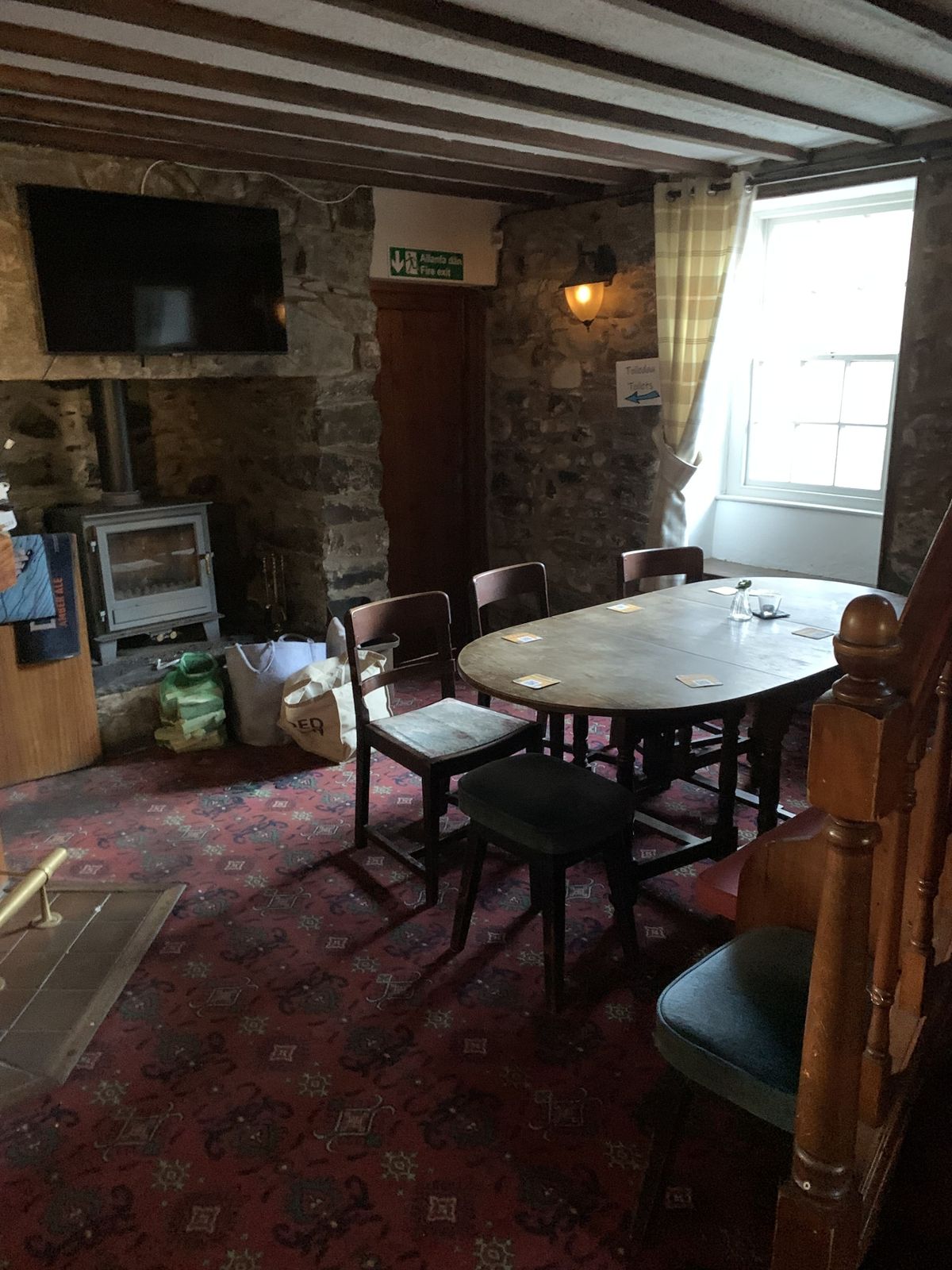 The renovation, conversion and transformation of T'yn Llan commnity pub in Llandwrog, Gwynedd - Inside one of the bar rooms in the old pub