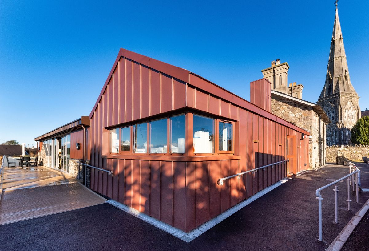 The cladding used on the new builds is zinc at The renovation, conversion and transformation of T'yn Llan commnity pub in Llandwrog, Gwynedd this is the new build extension with restaurant, catering kitchen, facilities and community room