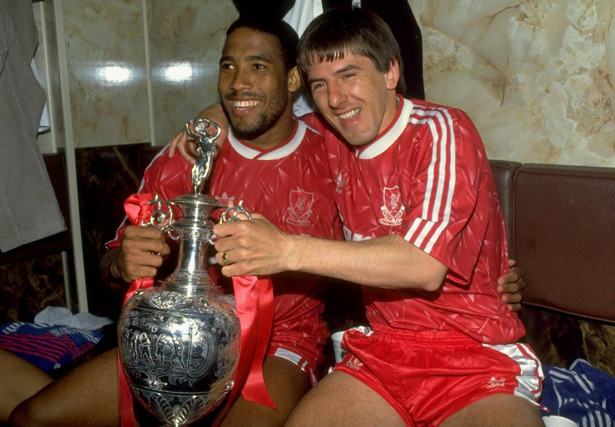 John Barnes and Peter Beardsley of Liverpool celebrate with the trophy after the Barclays League Division One match against Derby County