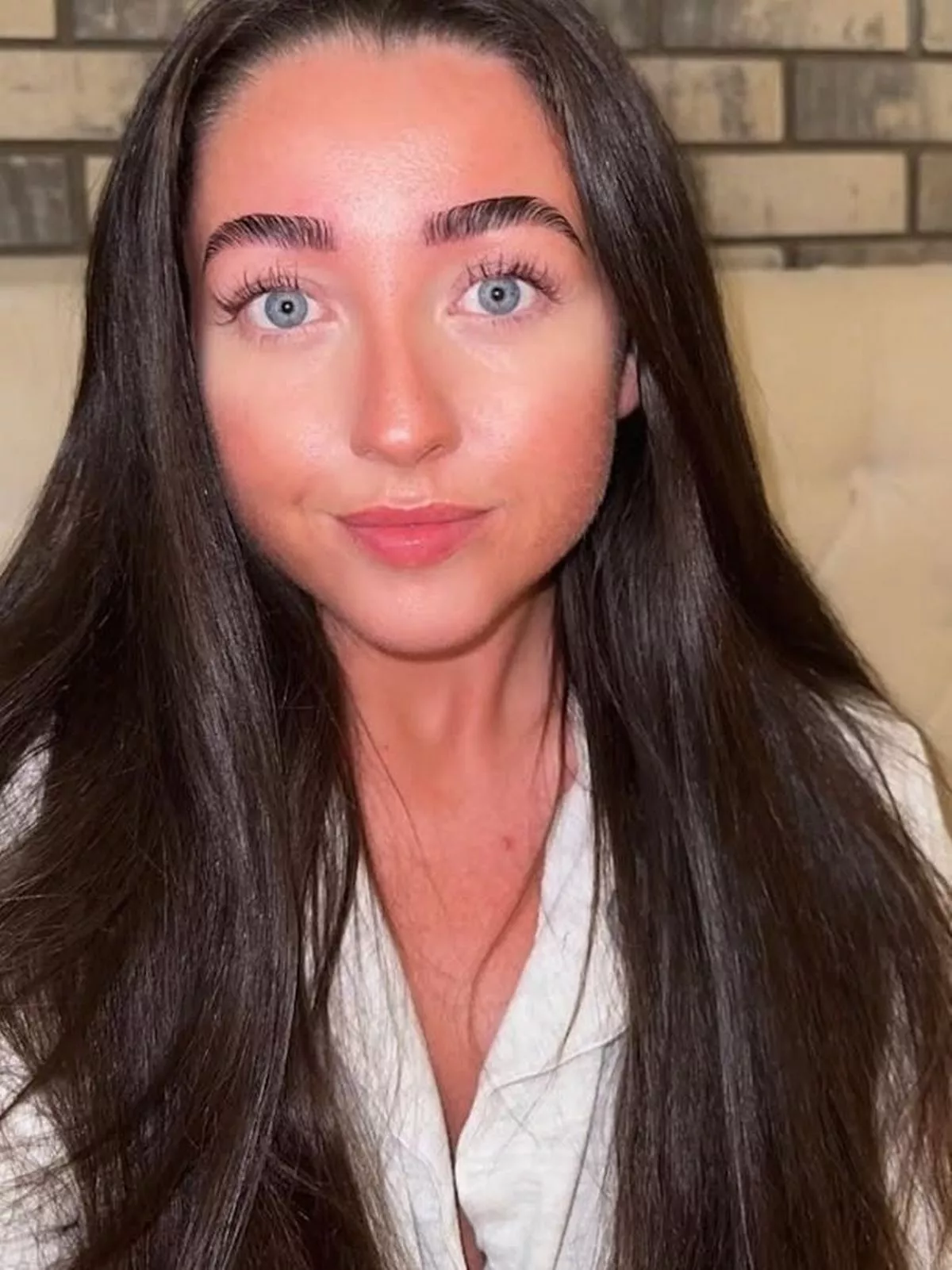 A dark-haired young woman with blue eyes