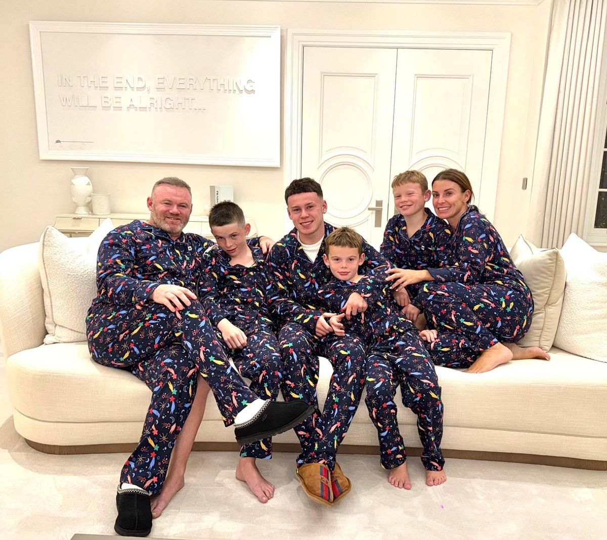 The Rooney family sitting on a sofa