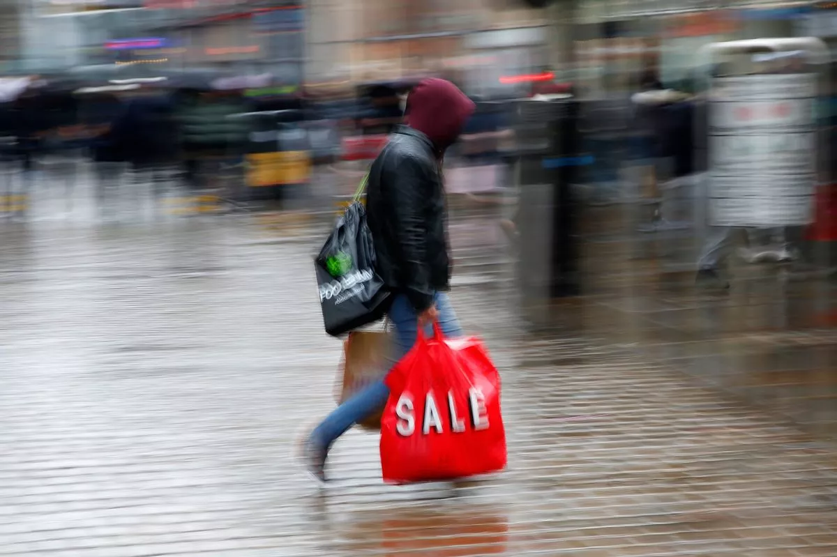 A general image of someone on the high street with shopping bags