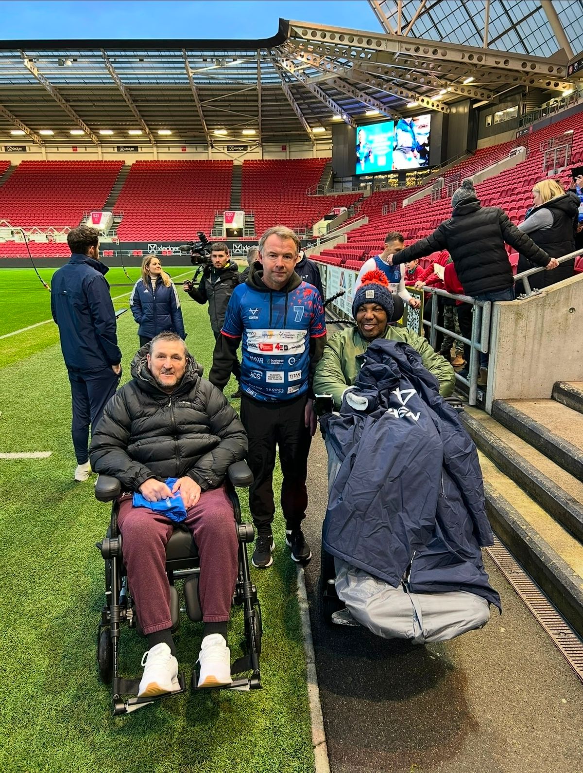 Bristol boxing coach legend Wayne Bridges, left, with David 'Syd' Lawrence, right, and Marcus Stewart at Ashton Gate to welcome Kevin Sinfield at the end of one of his charity runs for MND