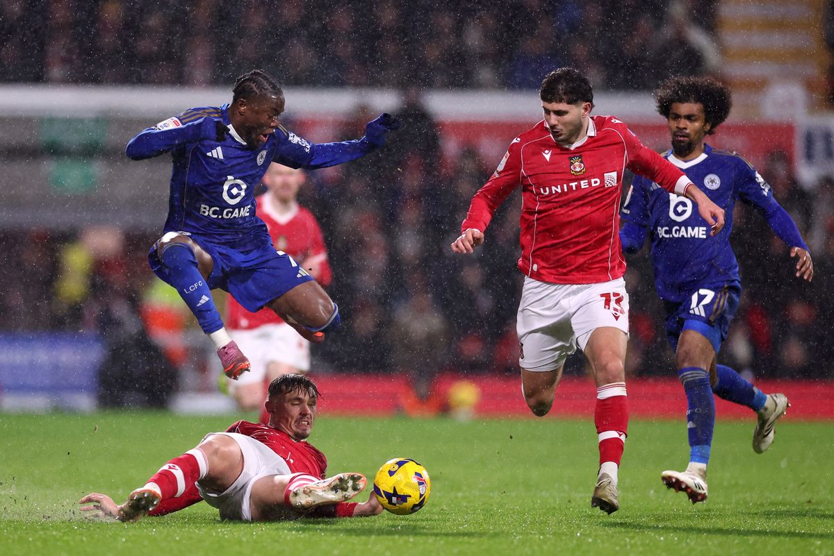 Abdul Fatawu of Leicester City is challenged by Callum Doyle of Wrexham