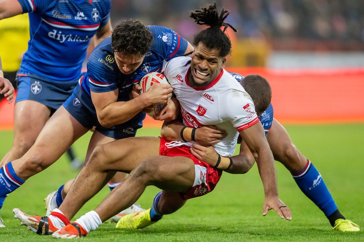 Hull KR's Jumah Sambou is tackled by Wakefield's Seth Nikotemo & Corey Hall.