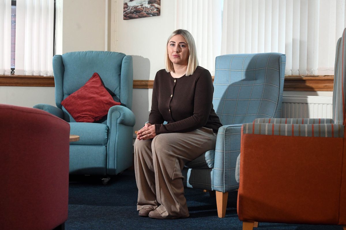 A young woman in a brown top