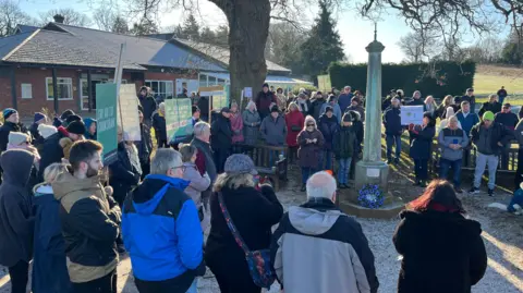 GEORGE CARDEN/BBC A group of people standing outside Ifield Golf Club as part of a protest against its proposed closure.