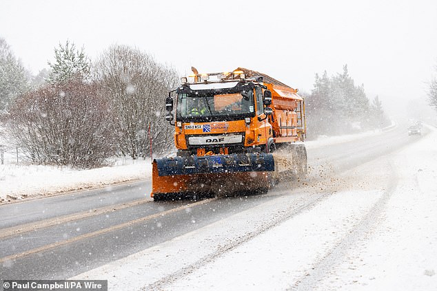 A Gritter lorry on the A9, south of Inverness, attempts to tackle the piling snow on the road