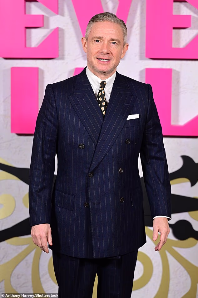 Martin looked dapper in a navy pinstripe double breasted suit, paired with a patterned tie and brown suede loafers