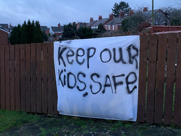 Locals have erected banners expressing their concerns over plans to house 70 migrants in the village