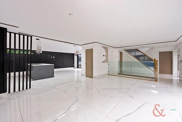 An estate agent listing for the property says it boasts 2,686 sq ft of living space, a modern open-plan layout, marble floors and 'sleek, high-quality fittings' throughout