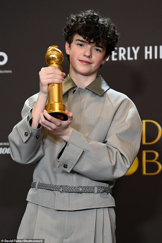 Owen Cooper raises his Golden Globe for his performance in Adolescence last weekend