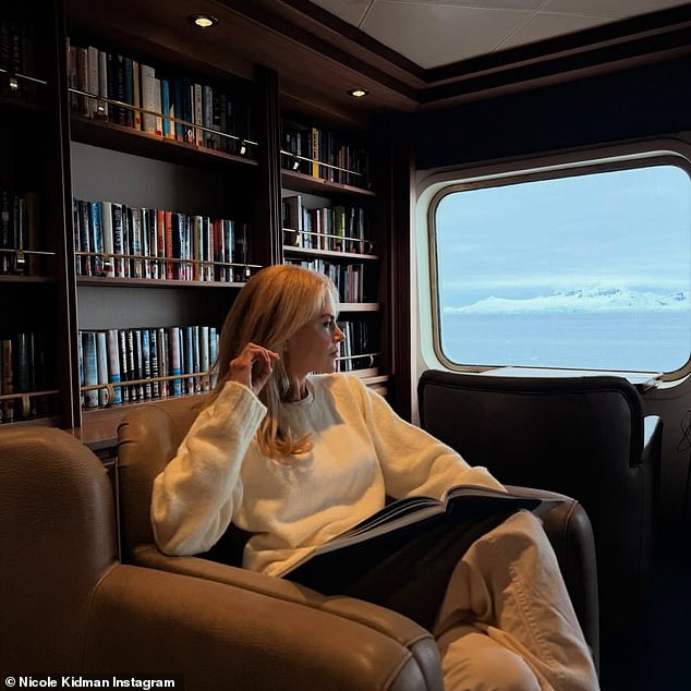 Nicole also shared another photo that showed her deep in thought as she sat in a book lined first-class cabin on her way to her adventure vacation