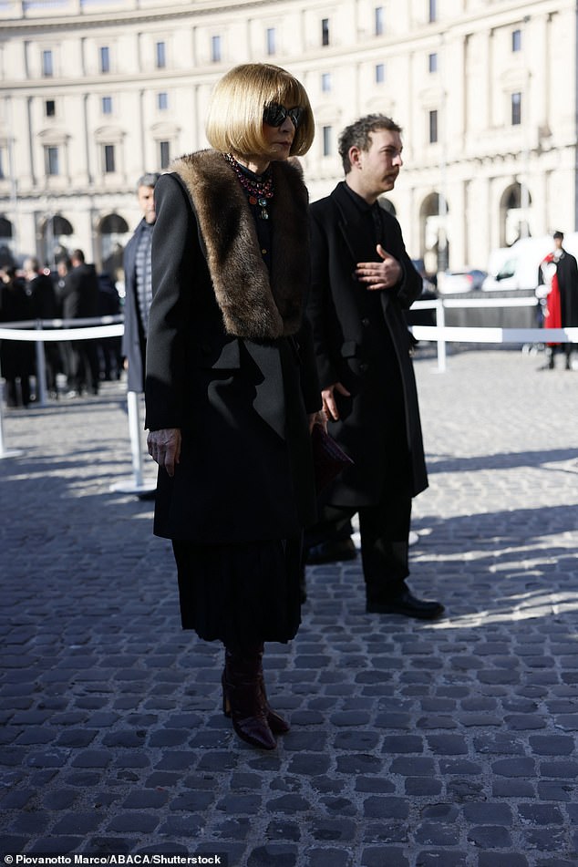 She added a fur stole and statement necklace to her outfit