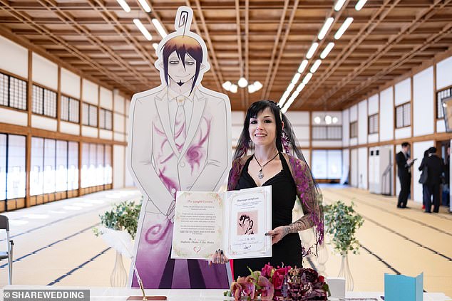Dis with a cardboard cutout of Mephisto Pheles, a character from a manga series, on their 'wedding day'. Photo courtesy of Dis and Share Wedding