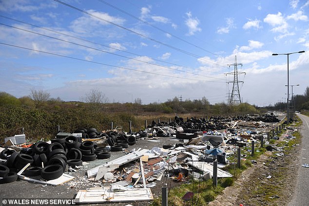 A huge pile of car tyres pictured amongst the waste on an abandoned dual carriageway in Newport