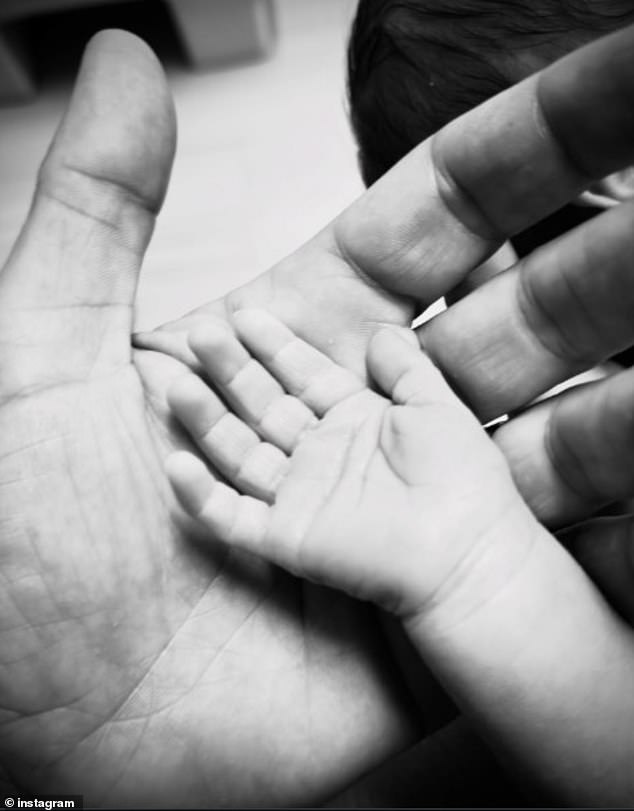 The Suits star, 44, quietly announced the arrival of the couple's third child on Tuesday by sharing a tender photo of his large hand gently cradling his newborn's tiny palm