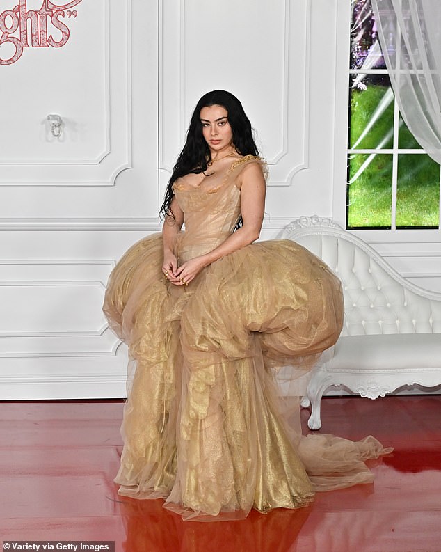 Charli xcx put on a busty display in a glimmering gold corset gown