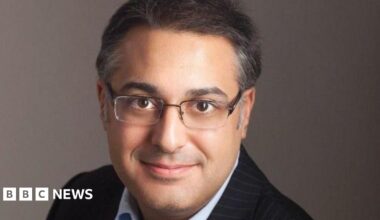 A photo of Mr Jabbar, who is wearing a suit and glasses