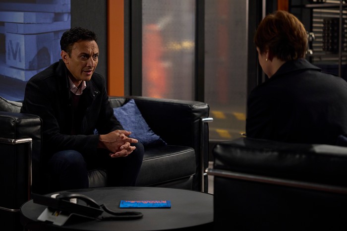 Jai chats to a police officer in the depot office in Emmerdale