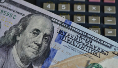 An illustration show a US dollar bill and a calculator at a bank in Fuyang, East China