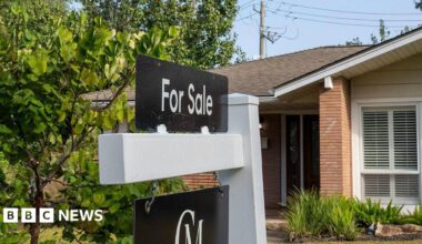 A for sale sign is seen in front of a house in a neighbourhood in Houston.