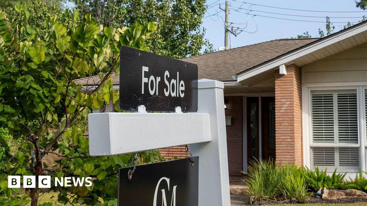 A for sale sign is seen in front of a house in a neighbourhood in Houston.