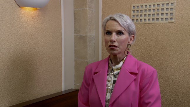 Debbie Webster standing in a witness box in court in Coronation Street, looking stunned.