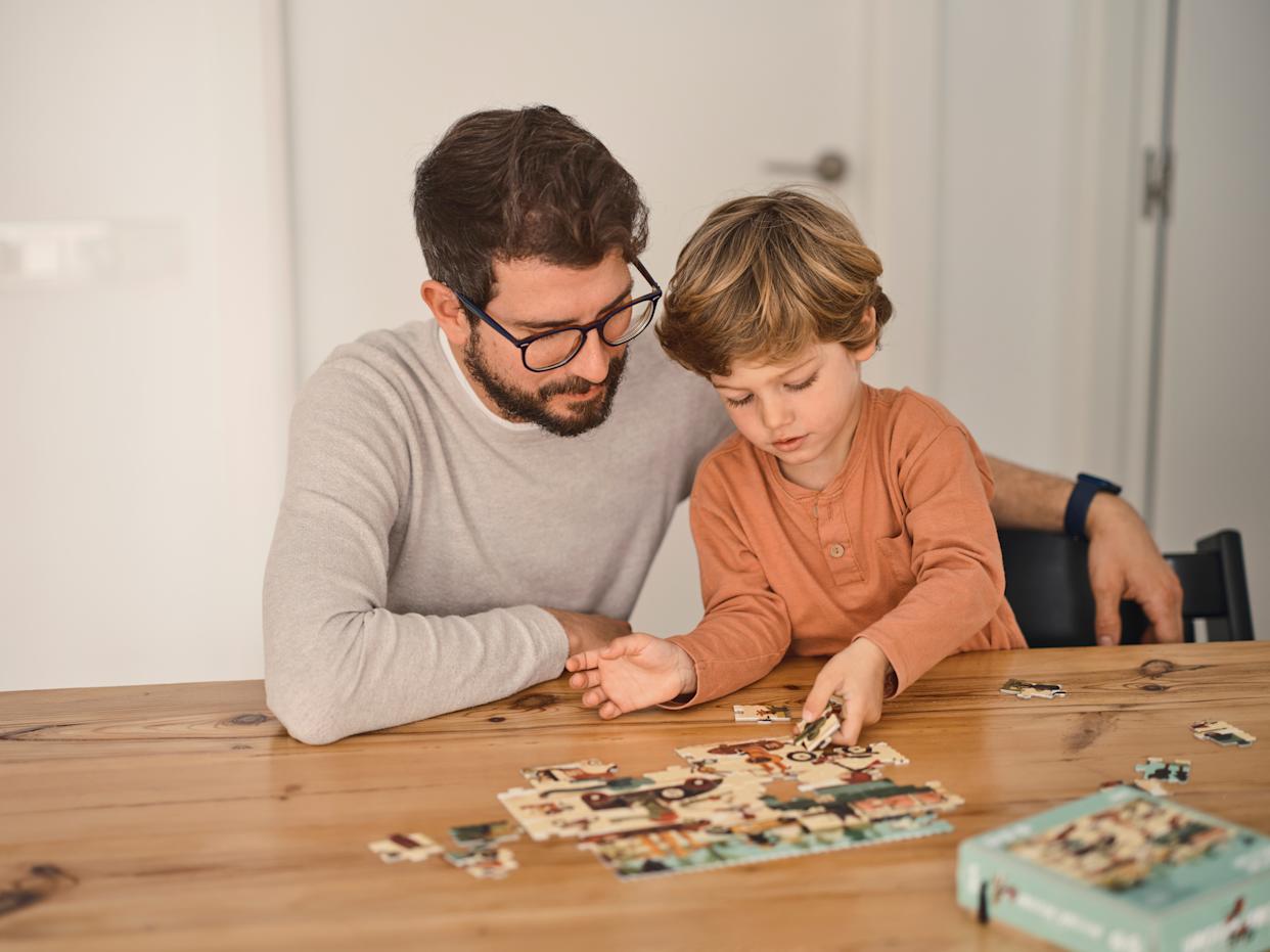 Father playing with puzzle game with son
