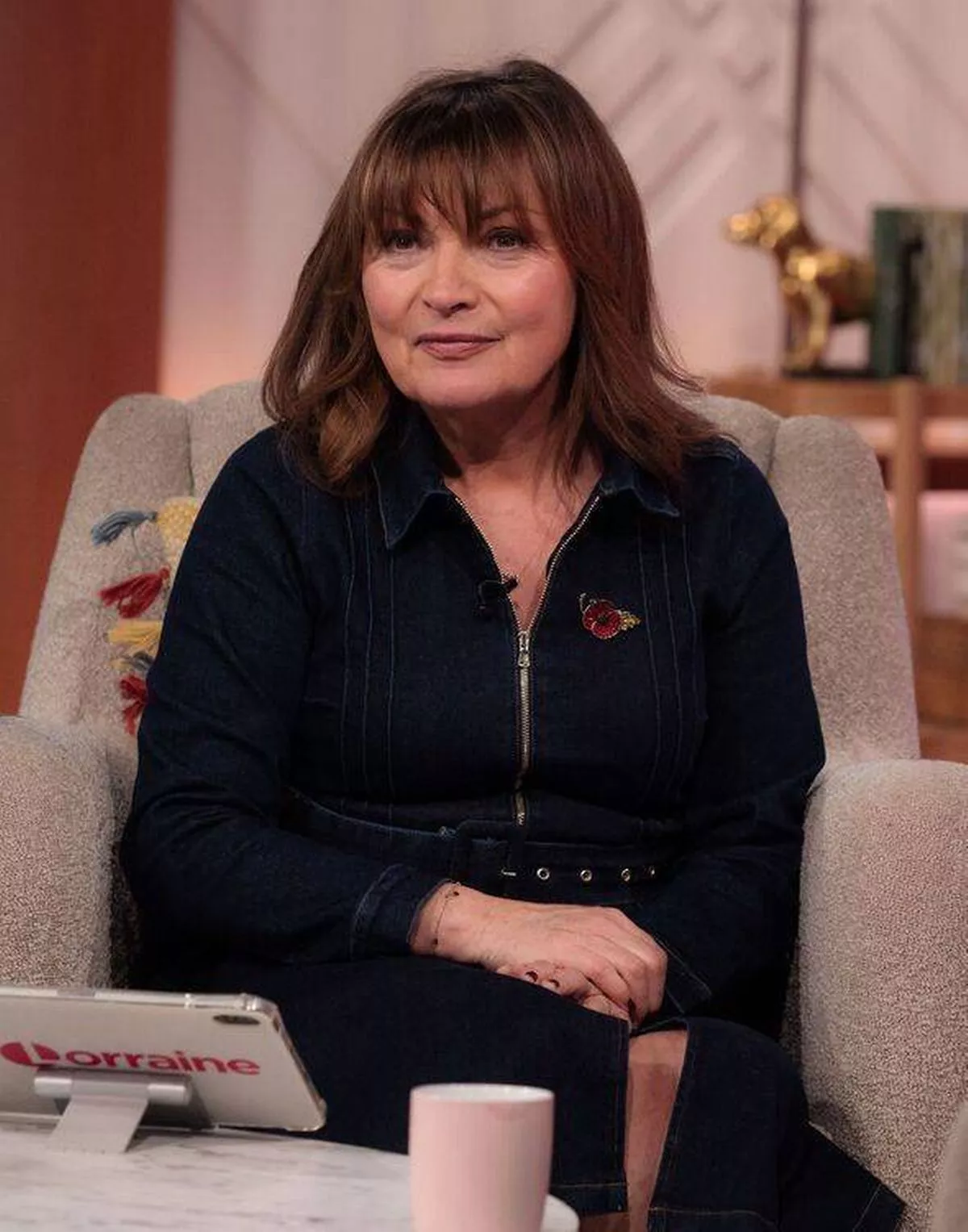 Lorraine Kelly sitting in a chair on the set of her show