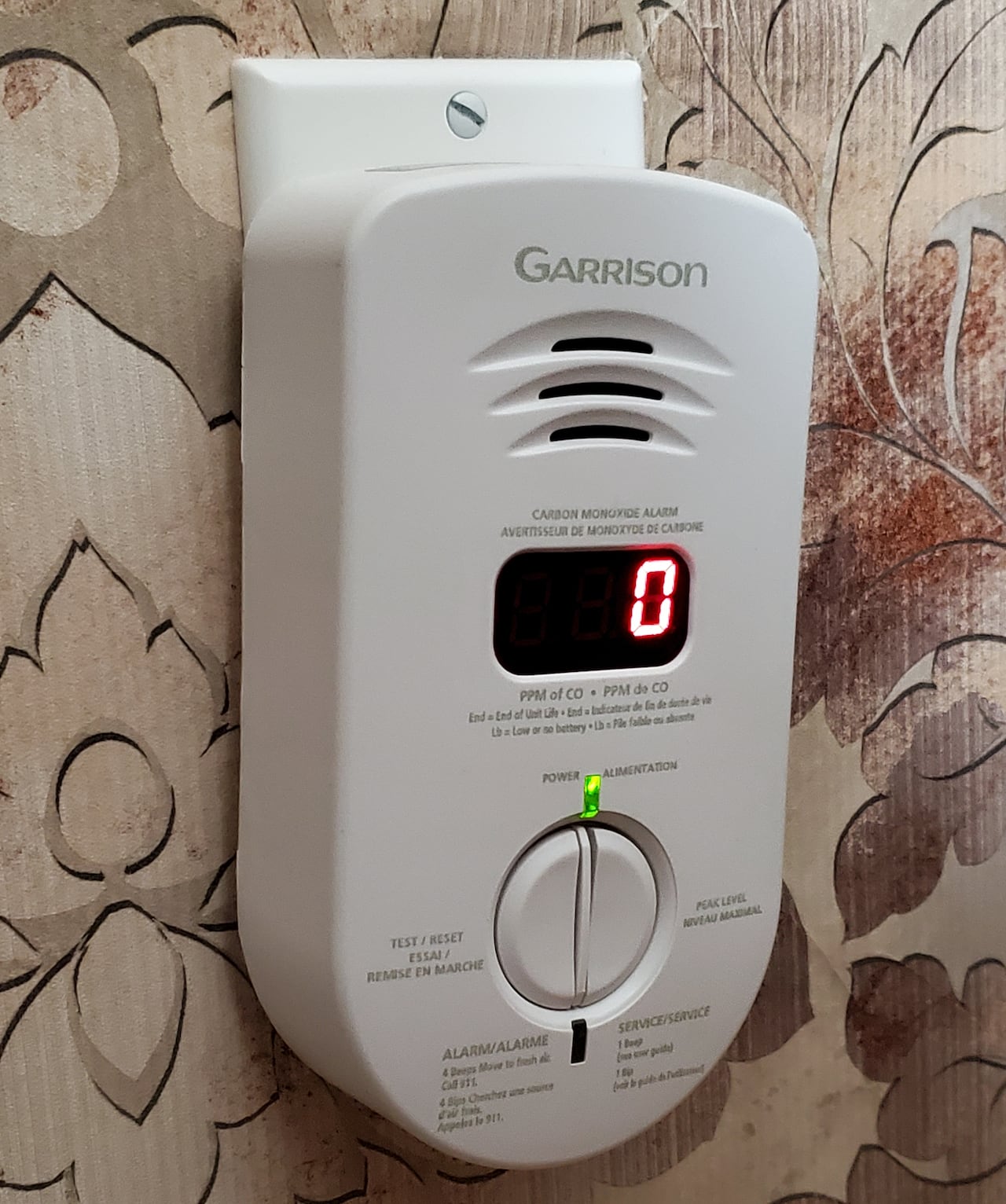 A carbon monoxide detector plugged into a wall.