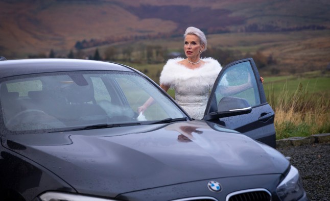 Debbie Webster climbing into a car in Corrie
