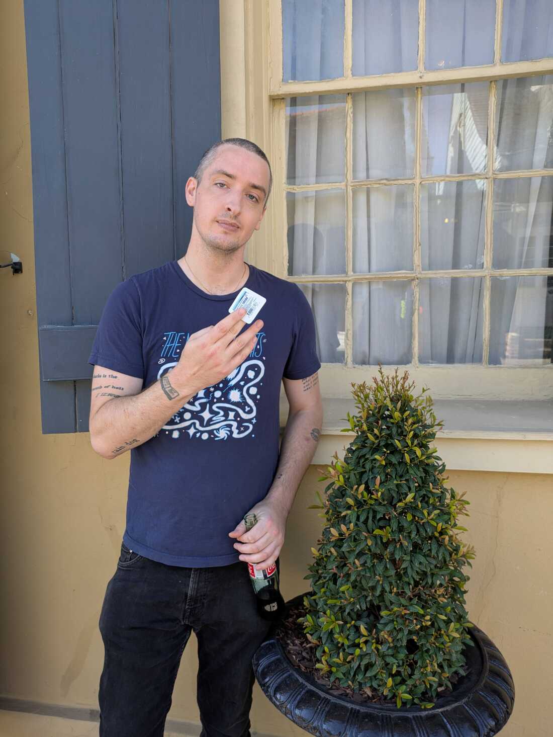 Luka Bair is a young person with close cropped hair, carrying a bottle of Coca-Cola. 