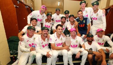 Australia players pose with the Ashes trophy in the SCG dressing rooms